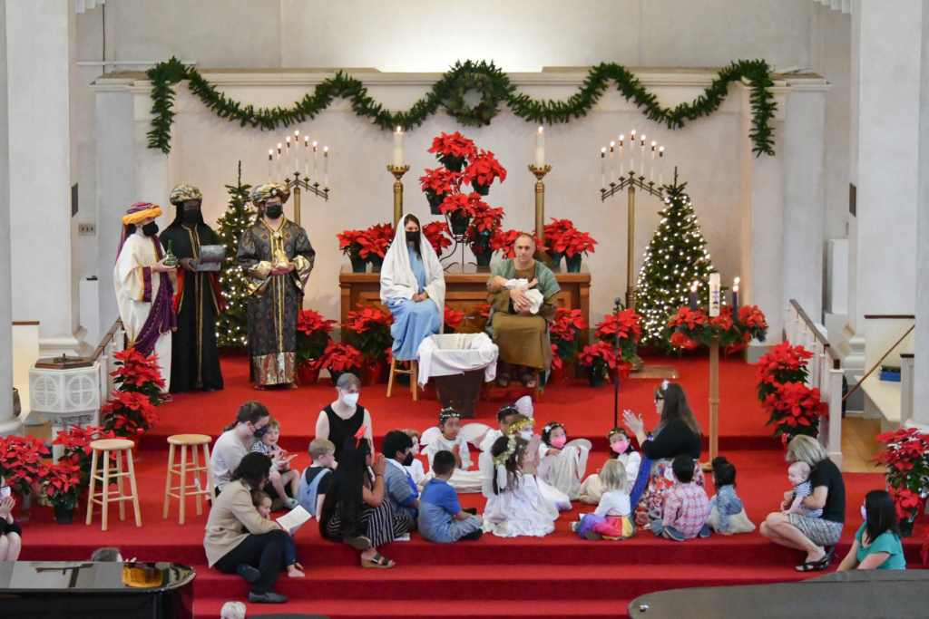 christmas pageant people are dressed up on chancel of sanctuary